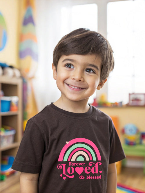 Smiling boy wearing a CIASARA boys graphic t-shirt with colorful rainbow and text design